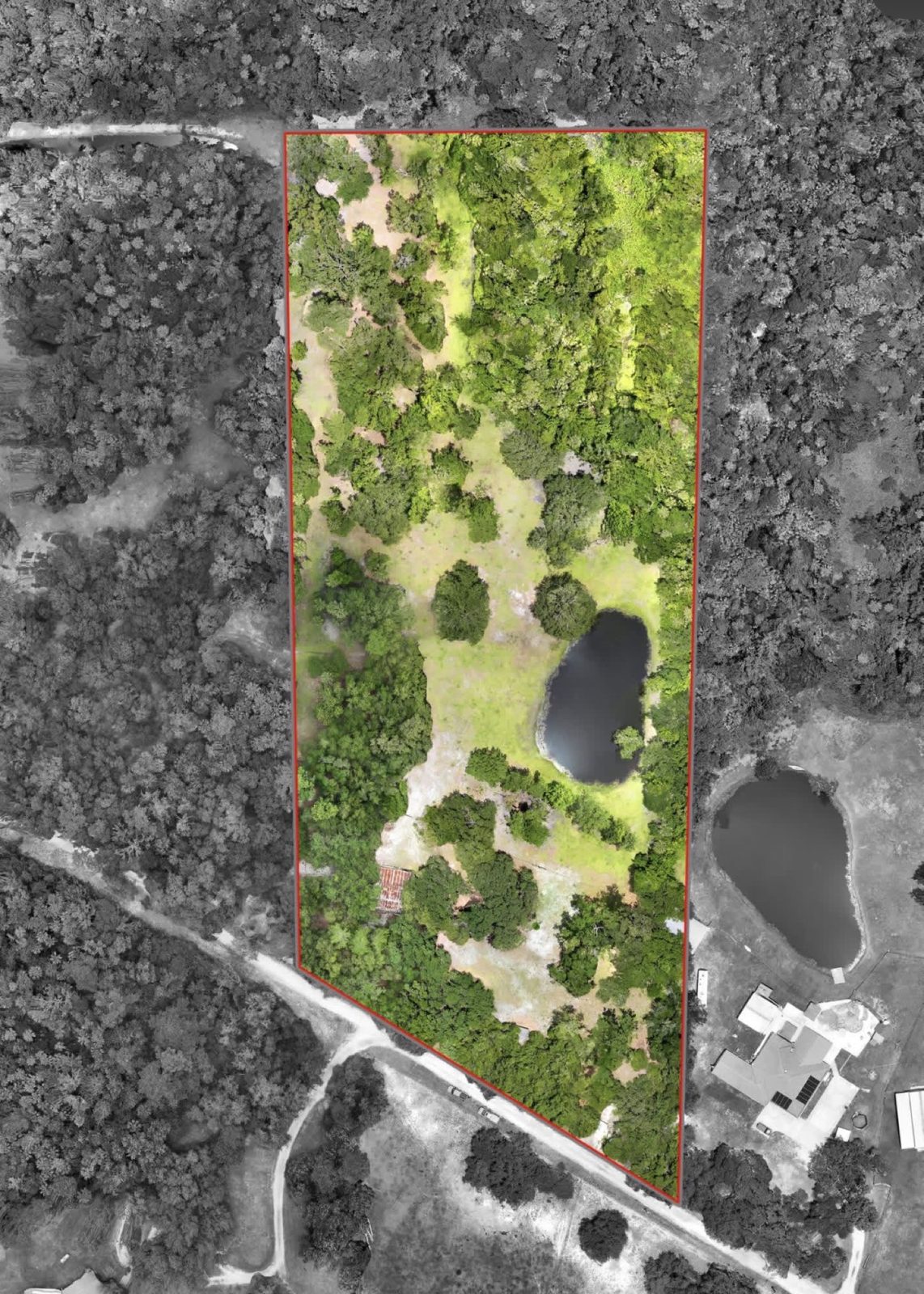 Top-down aerial with the parcel highlighted for a land listing